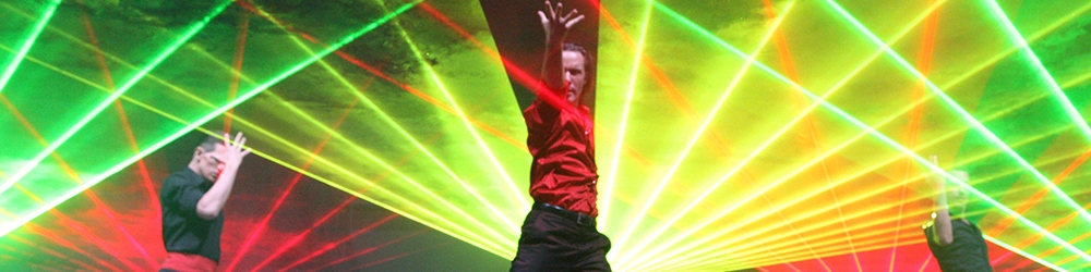 photo of performers dancing on stage with lasers