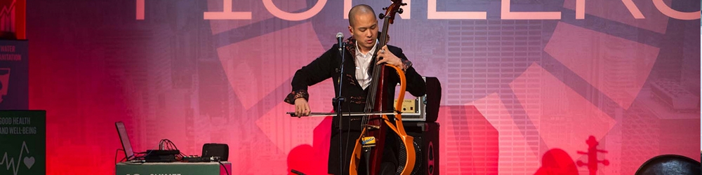 photo of a man playing a electric cello