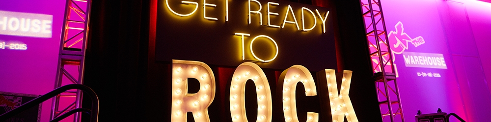 photo of neon set piece that says "GET READY TO ROCK"